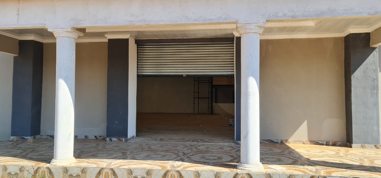 Roller shutter door installed behind the columns of a building under construction